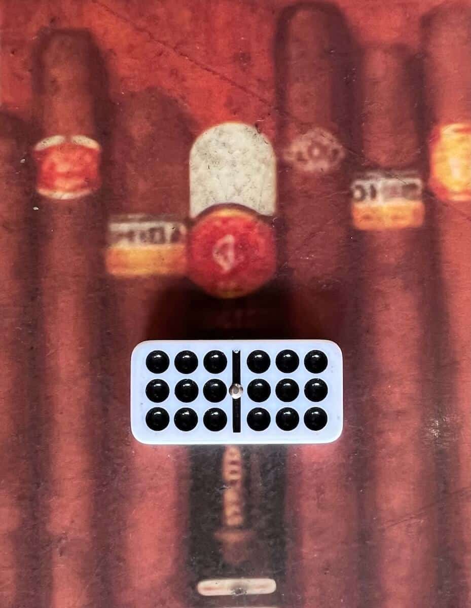 double-nine domino on table with images of cigars